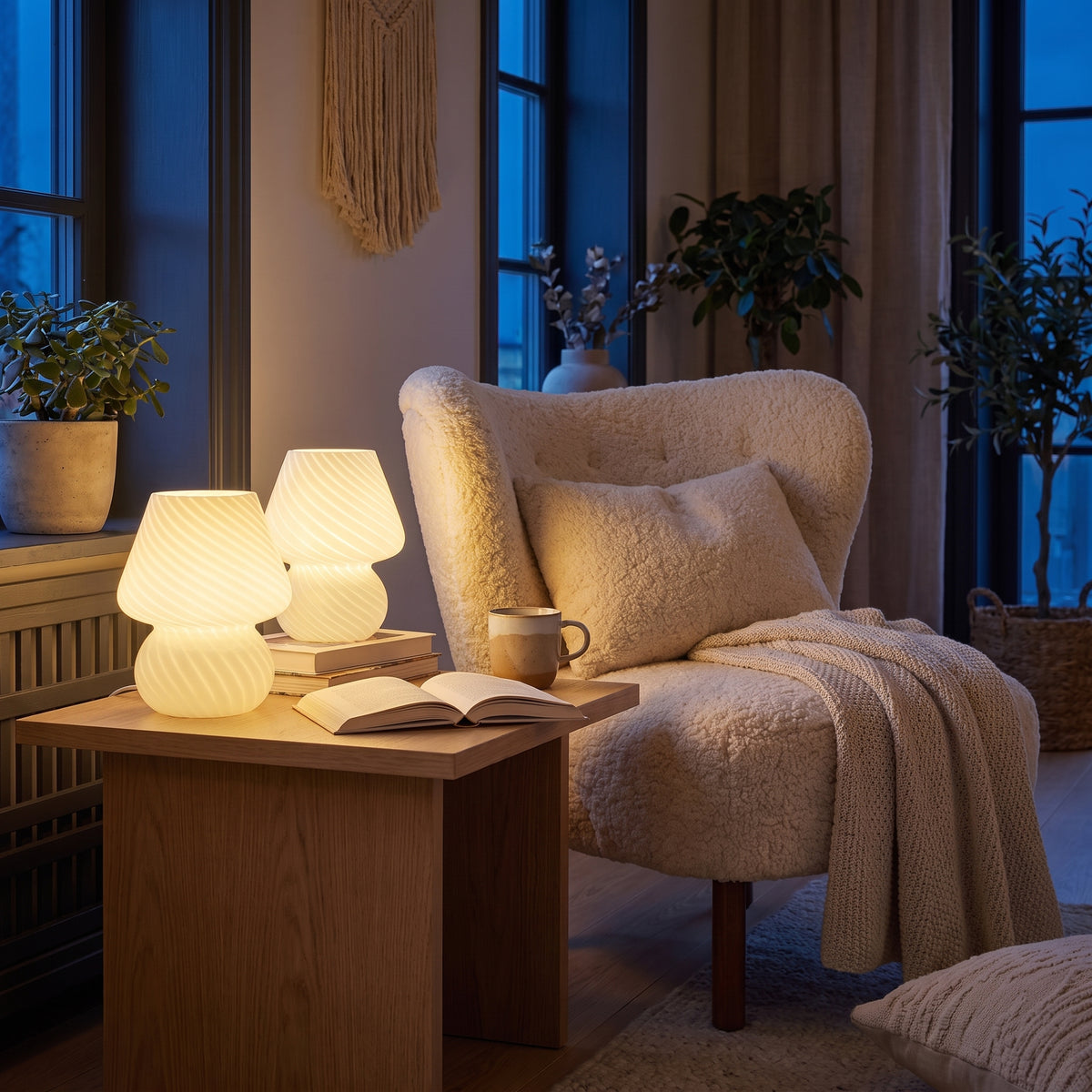 Mushroom table lamps glowing beside a boucle armchair in a cozy living room