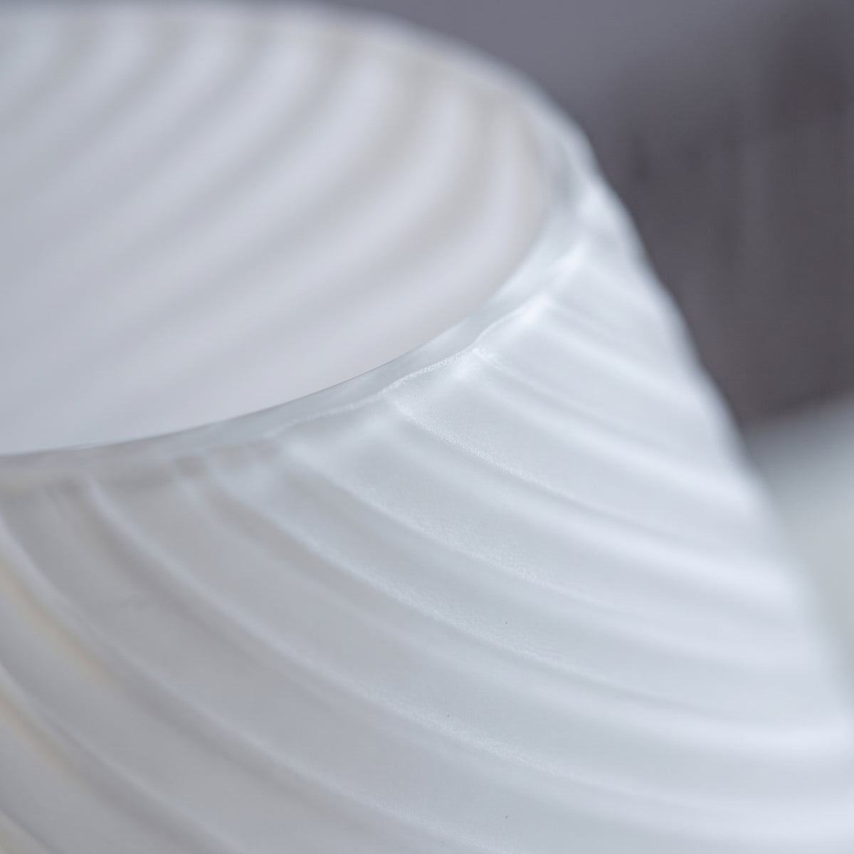 Close-up of the frosted swirl-ribbed glass of the Sereluma mushroom lamp
