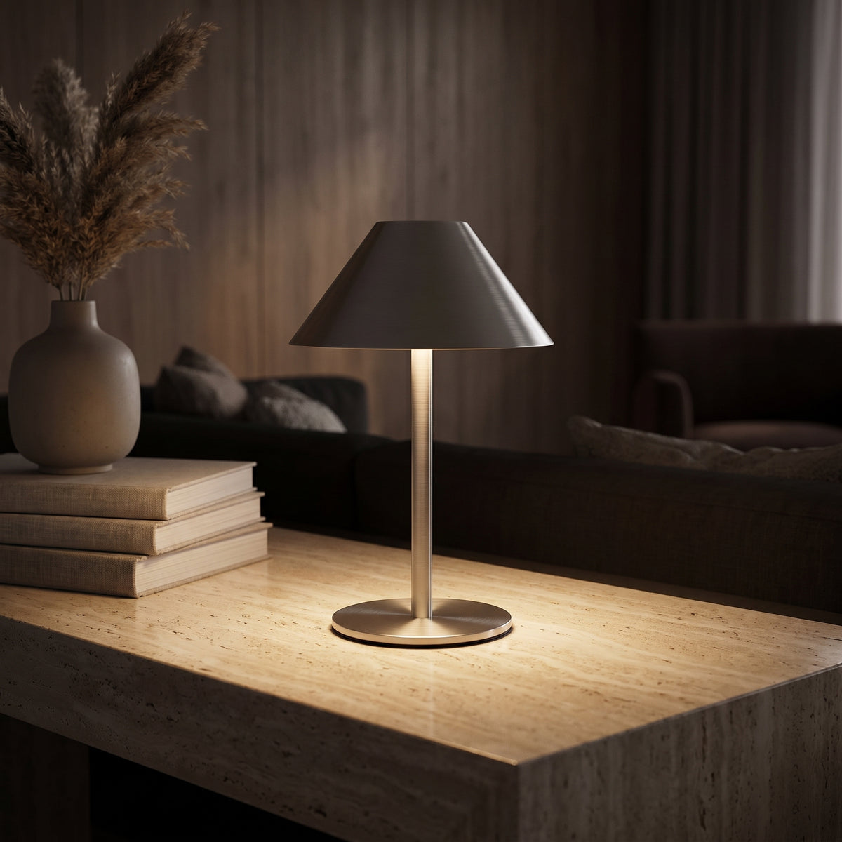 Bedside lamp casting a warm circle of light on a travertine console at night