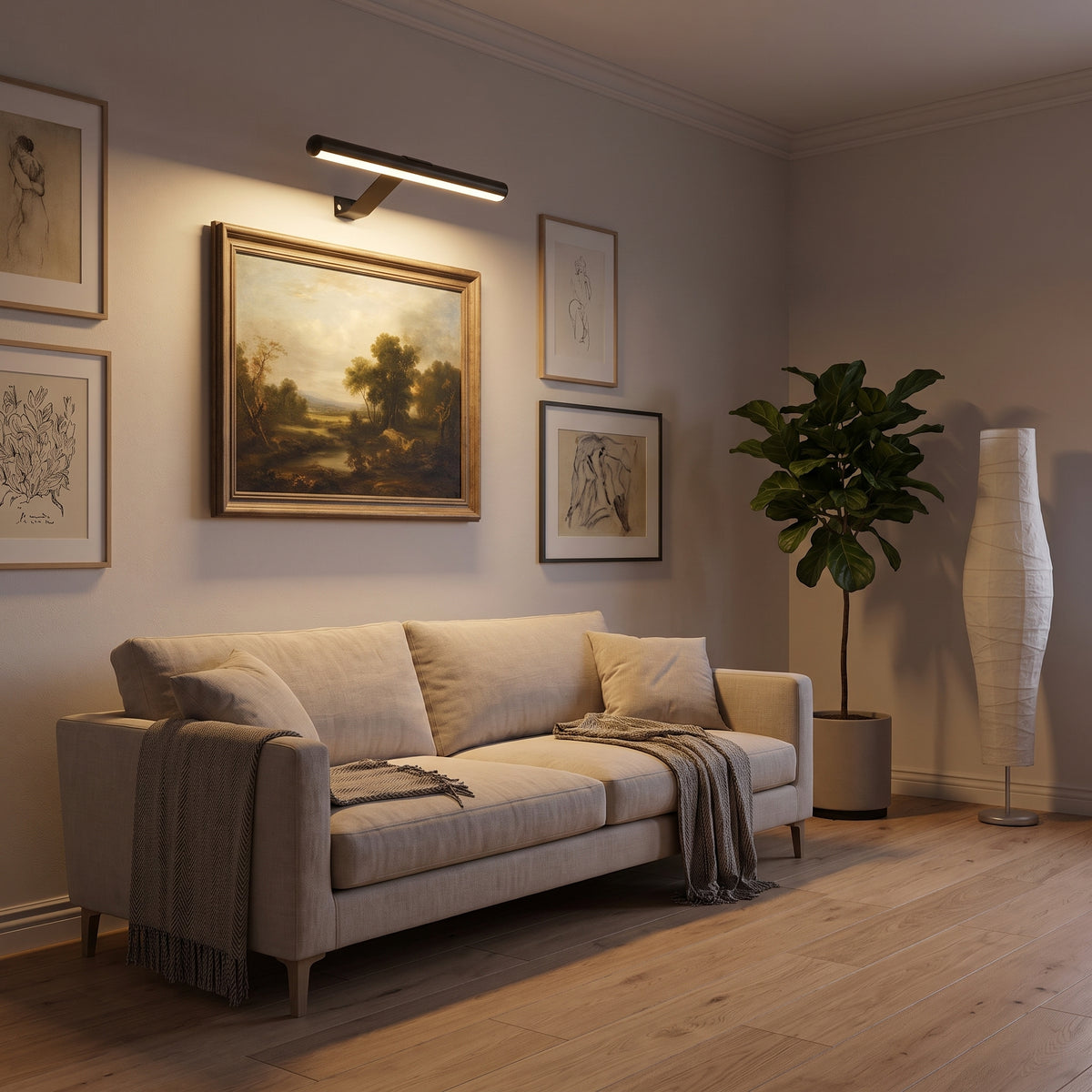 Living room gallery wall with one artwork lit by the rechargeable picture light