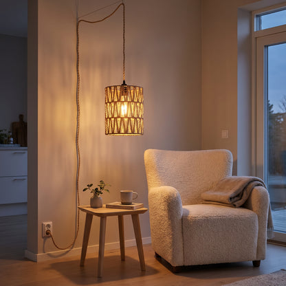 Plug-in pendant hanging above a reading corner with a boucle armchair