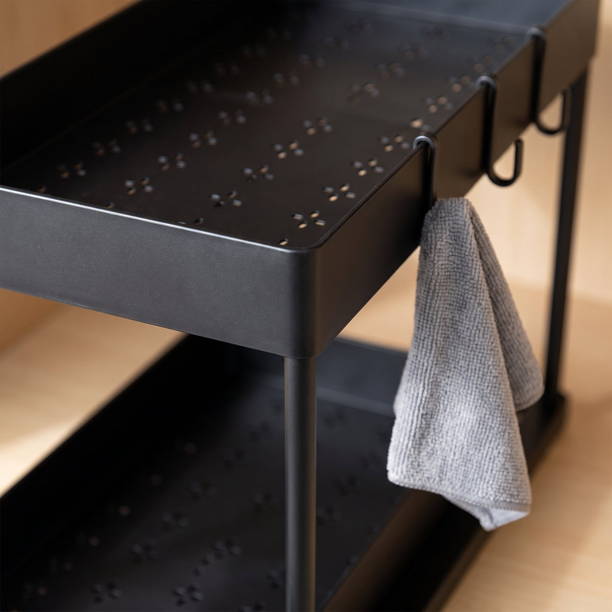 Close-up of the perforated shelf and side hook of the organizer