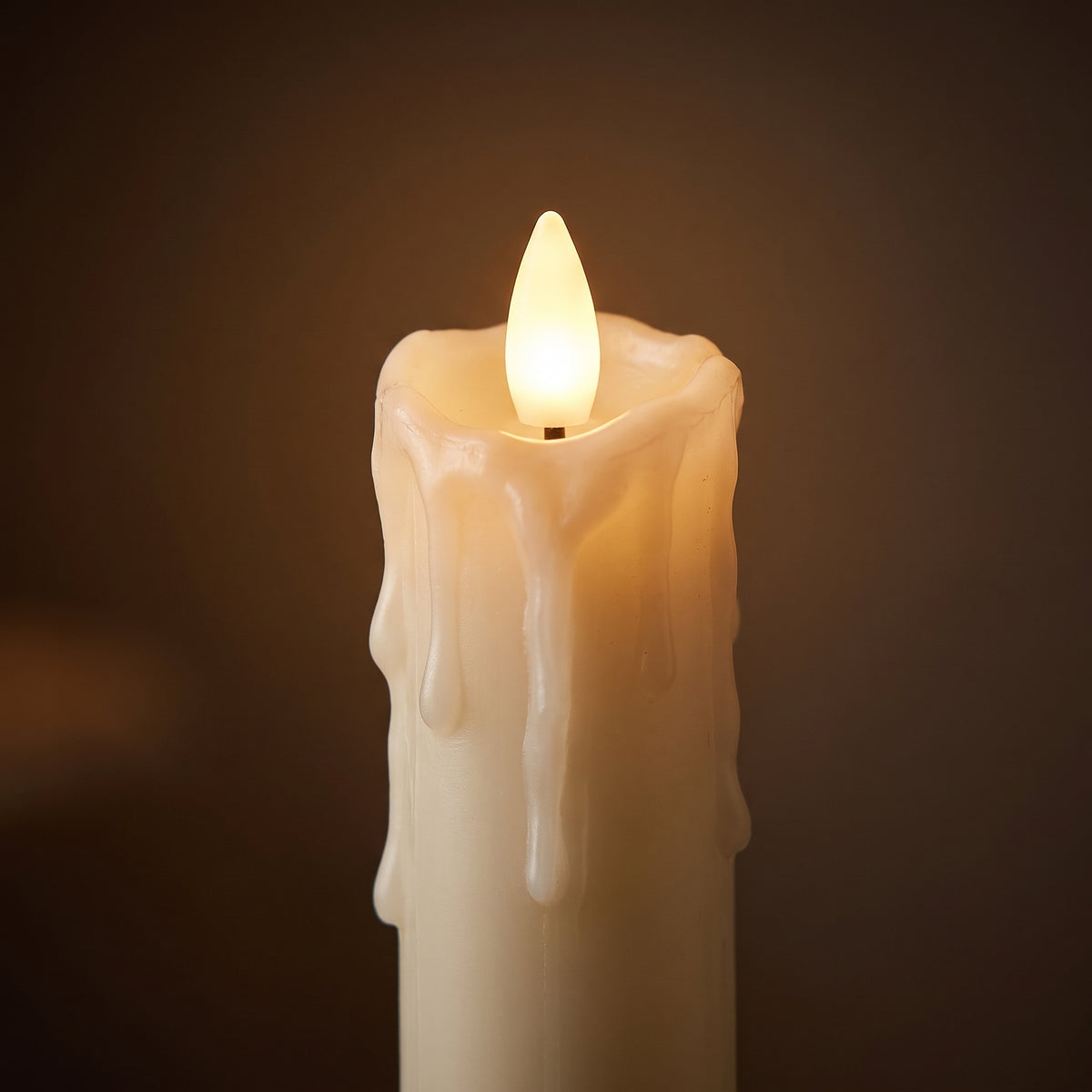 Close-up of the ivory dripping-wax finish and the warm LED flame tip